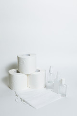 Hygiene supplies antiseptic gel, surgical mask, antibacterial spray, toilet paper on white background. COVID-19 coronavirus outbreak concept. Shortage due to buying panic. White background, copy space