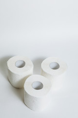 A supply of several rolls of toilet paper in case of an epidemic. COVID-19 coronavirus outbreak concept. Shortage due to buying panic. White background, copy space