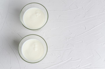 Home-made fermented kefir drink on a white background, copy space, place for text. Sour milk drink, sourdough for yeast bacterial fermentation, intestinal health concept. View from above