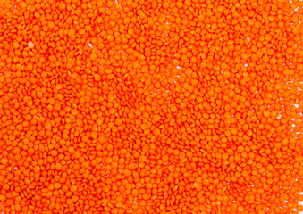 Dry orange lentils for vegans as a background, copy space, place for text. Healthy foods high in protein and carbohydrates. View from above. Horizontal orientation.