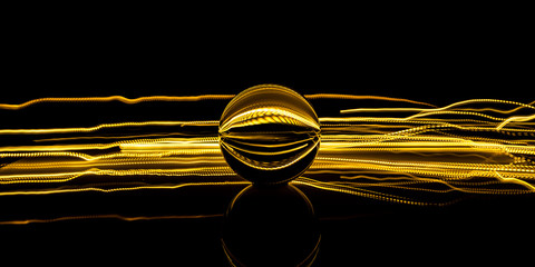 Crystal sphere light painting. Golden energy trails in black background
