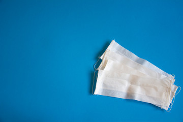 Still life of a face mask on blue background