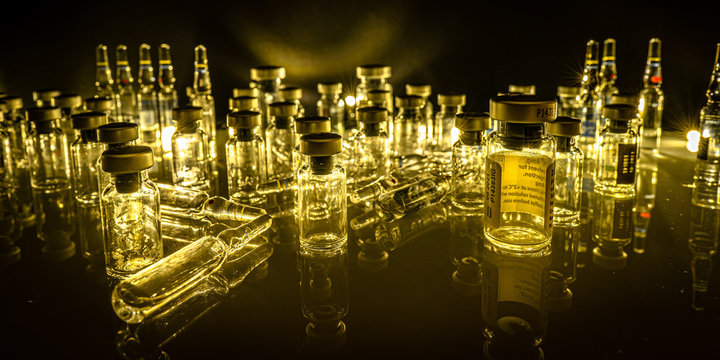 Glass medical ampoule and vials. Black background. Virus vaccination and social health.