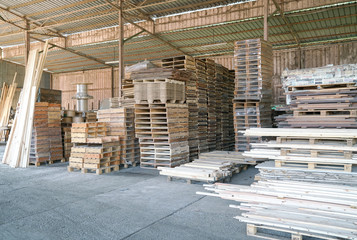 Stacked pine wood in a warehouse. Wood processing, wood for furniture.