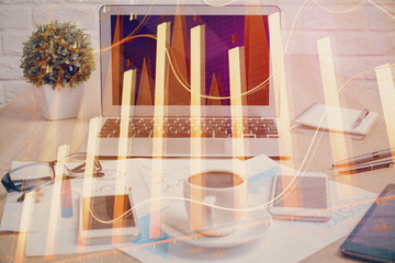 Stock market graph and table with computer background. Double exposure. Concept of financial analysis.