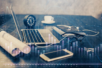 Financial chart drawing and table with computer on background. Multi exposure. Concept of international markets.