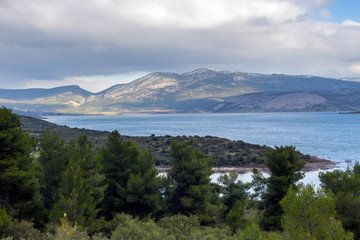 A view of the natural Lake Yliki (Boeotia, Greece) and mountains around on a cloudy winter day