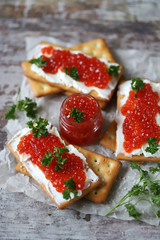 Crackers with red caviar. Healthy snack.