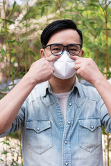 Asian men adjust to wear medical masks on the streets of the city