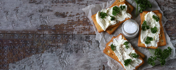 Cream cheese crackers and herbs. Healthy snack.