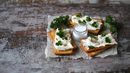 Cream cheese crackers and herbs. Healthy snack.