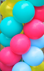 Colorful round balloons in yellow, red and blue.