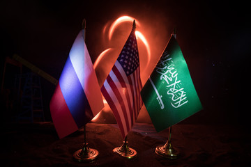 Business dialogue, oil agreement concept: National flags with Oil pump and oil refining factory at...