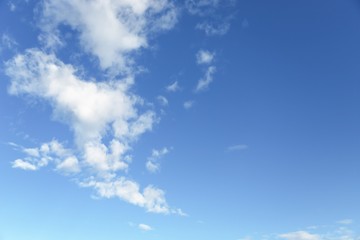 Naklejka na ściany i meble Blue sky background. Blue sky with fluffy white clouds. Copy space
