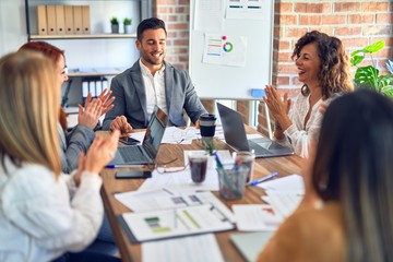 Group of business workers smiling happy and confident. Working together with smile on face applauding one of them at the office