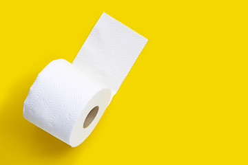 Toilet paper on yellow background.