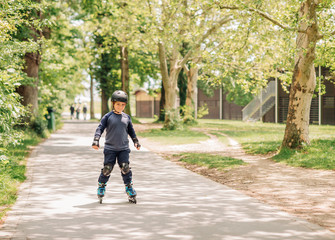 Active little boy skating in summer park, healthy lifestyle for children