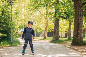 Active little boy skating in summer park, healthy lifestyle for children