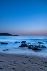 Fototapeta na wymiar Iridescent Blue Dawn Seascape with Crescent Moon