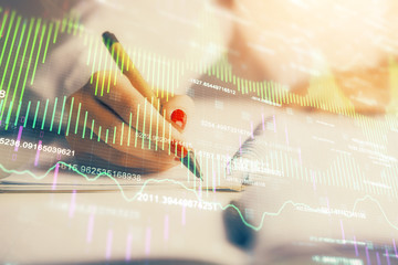 Double exposure of woman's hands making notes with forex graph hologram. Concept stock market analysis.