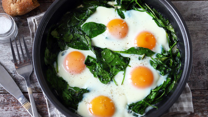 keto diet. Healthy omelet with spinach. Eggs with spinach in a frying pan.