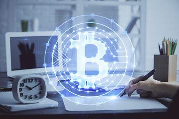 Cryptocurrency hologram over hands taking notes background. Concept of blockchain. Multi exposure