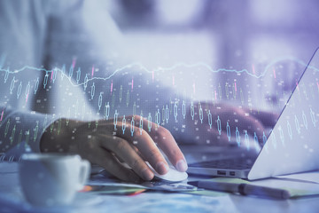 Double exposure of forex graph with man working on computer on background. Concept of market analysis.