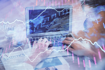 Multi exposure of forex graph with man working on computer on background. Concept of market...