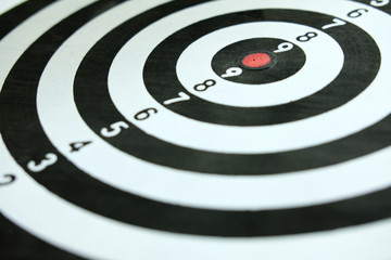 Conceptual photo of business strategy / accuracy - a red arrow that sticks directly in the center...