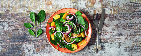 Green fresh detox salad with spinach and orange. Healthy food concept. Super food.