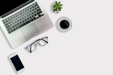 White office desk with laptop black coffee cup and glasses Top view with copy area