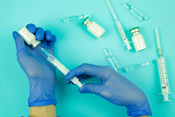 doctor's hands with syringe and vaccine, pandemic virus vaccination, medical healthcare and treatment concept