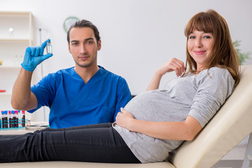 Young pregnant woman in blood transfusion concept