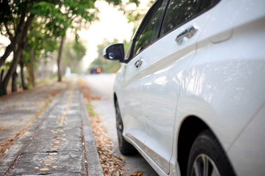 White Car On Parking,Close Up Side Of White Car On The Road