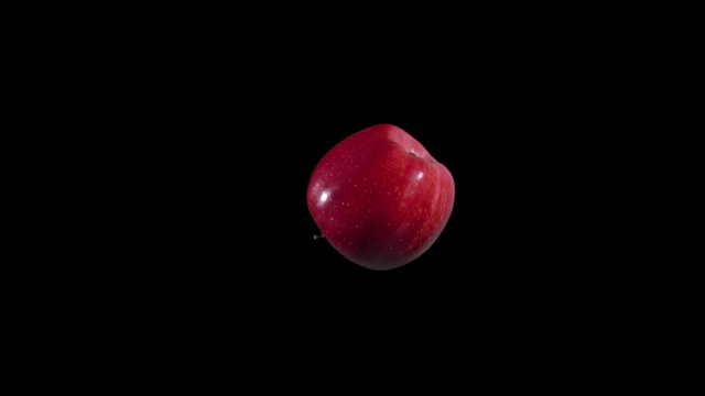 Slow motion of Real delicious red apple spinning rotating and taken off green screen WITH ALPHA CHANNEL included