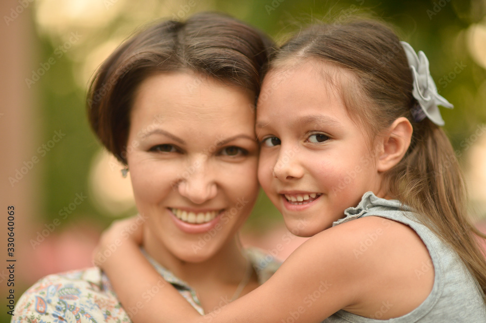 Wall mural happy mother and daughter at summer field