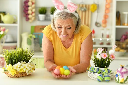 Happy Senior Woman Wearing Rabbit Ears Preparing To Easter