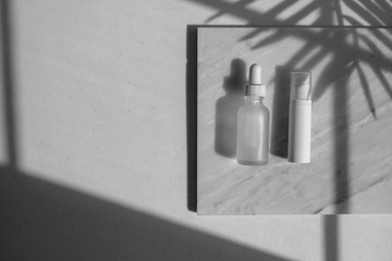 cosmetic skincare packaging . beauty product mock up on luxury white marble with natural light and shadow.