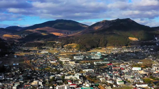 Scenic aerial cityscape of Yufuin, Japan with mountains in background