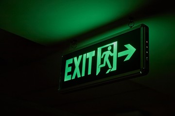 Emergency exit sign glowing in the dark