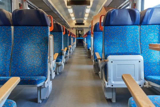 Interior of a passenger train with empty seats