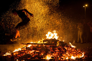 Jóvenes saltando el fuego en las hogueras de San Juan en Pamplona