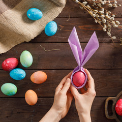 Still life of easter eggs in a bird's nest on a wooden background. Rustic. Decoration of natural. Easter celebration concept. Copy space. Flat lay. Square.