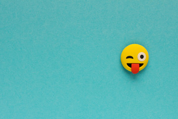 Yellow funny smiley face on blue background. Positive mood concept.