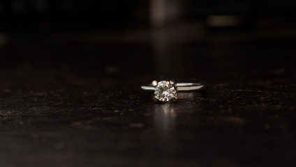 Wedding ring Is a diamond ring on the wooden floor