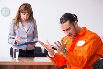 Young man meeting with advocate in pre-trial detention