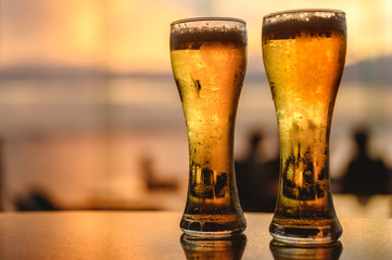 Glass of beer a shadow on the sky bar counter in restaurant. Draft beer in happy hour buy 1 get 1 free. Cold beer, perfect for hang out after work. Beer, hang out, relax, restaurant, dinner concept.
