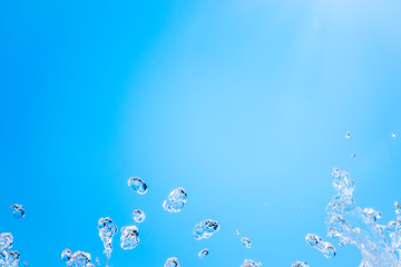 Splashes of water against the blue sky background