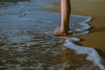 Vacation and holiday concept,Woman legs or foot walking on the beach