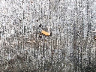 Smokers are littering cigarette butts on the public.